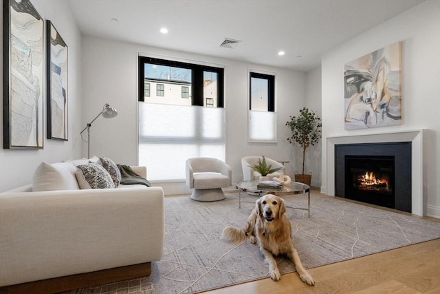 100 Linden St Unit 102, Wellesley, MA 02482 - living room with a warm lit fireplace, recessed lighting, and wood finished floors