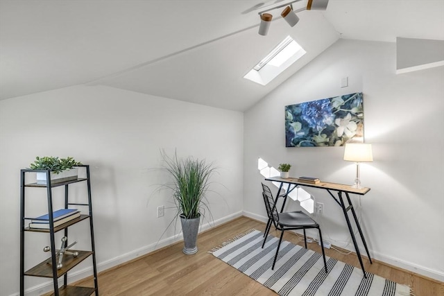 office area featuring lofted ceiling with skylight and wood-type flooring