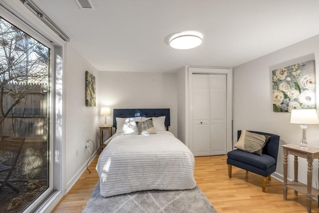 bedroom featuring hardwood / wood-style floors and a closet