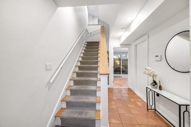 stairway featuring tile patterned flooring