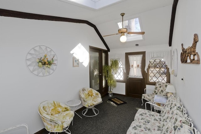 carpeted entrance foyer with lofted ceiling with skylight