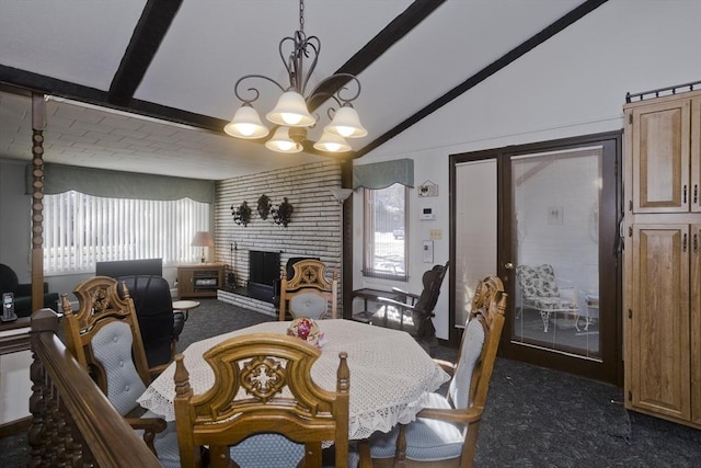 dining space with a notable chandelier, a brick fireplace, vaulted ceiling with beams, and dark colored carpet