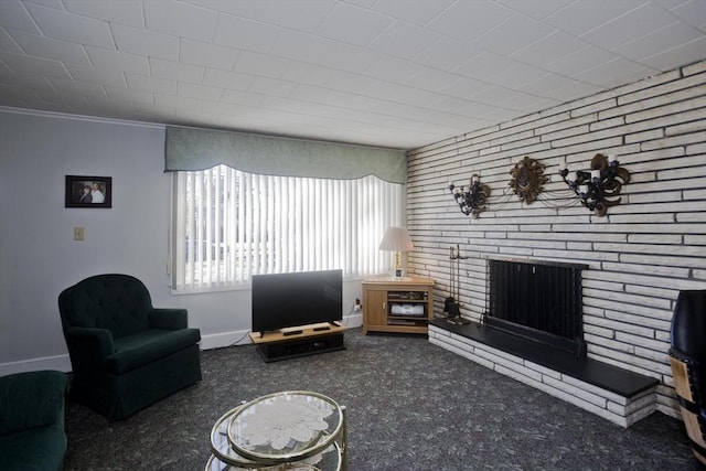 living room featuring a fireplace, brick wall, baseboards, and carpet floors