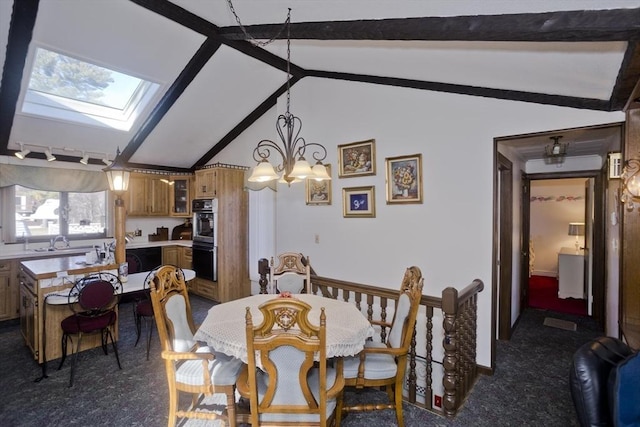 dining space with dark colored carpet, lofted ceiling with skylight, and track lighting