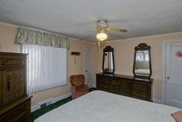 bedroom featuring visible vents, ceiling fan, baseboards, and ornamental molding