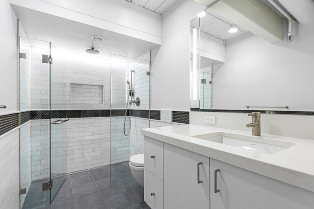 bathroom with an enclosed shower, tile patterned floors, toilet, and vanity