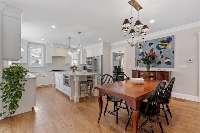 dining space with baseboards, light wood-style flooring, ornamental molding, an inviting chandelier, and recessed lighting