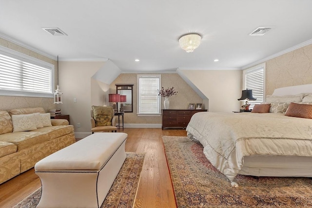 bedroom featuring multiple windows, visible vents, and crown molding