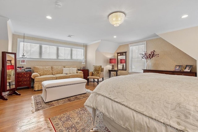 bedroom featuring light wood-type flooring, visible vents, crown molding, and recessed lighting