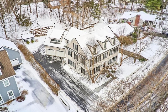 snowy aerial view with a residential view