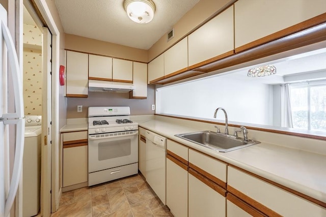 kitchen featuring white cabinetry, sink, washer / clothes dryer, white appliances, and a textured ceiling