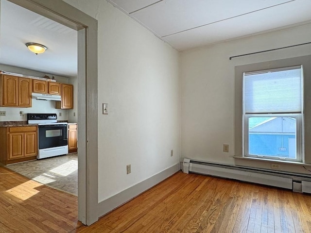 interior space with baseboard heating and light hardwood / wood-style flooring