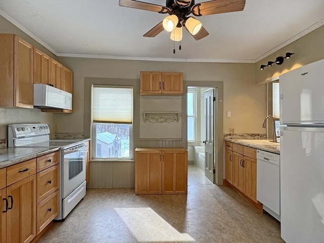 kitchen with sink, light stone counters, ceiling fan, crown molding, and white appliances