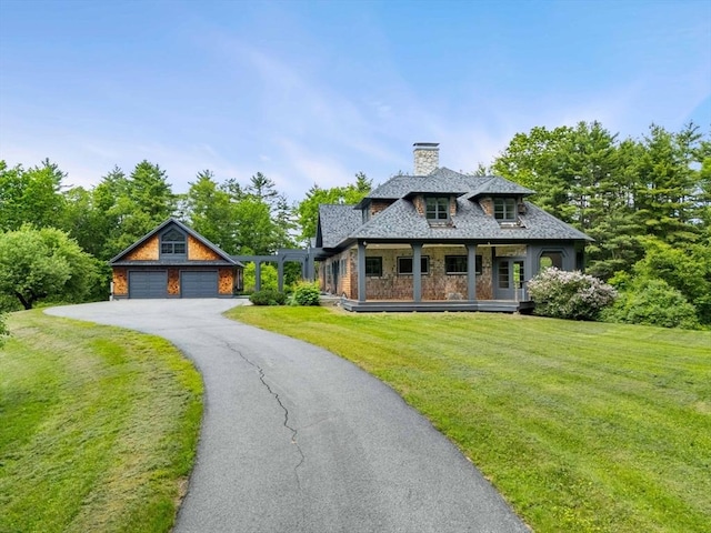 7 Penhollow Ln, Hampton Falls, NH 03844 - view of front of home featuring a chimney, a front yard, covered porch, an outbuilding, and a garage