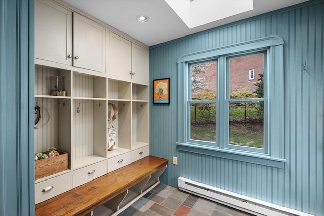 mudroom featuring a baseboard heating unit, a wealth of natural light, and a skylight