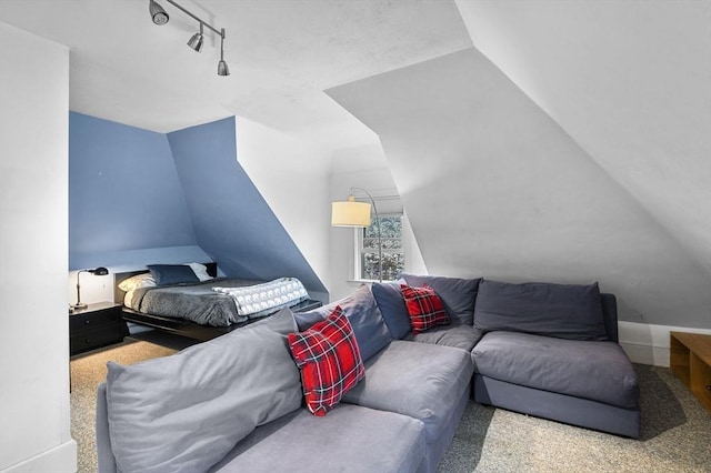 bedroom with lofted ceiling and rail lighting