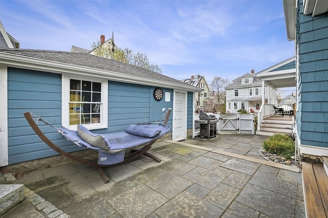 view of patio / terrace with fence, grilling area, and a gate