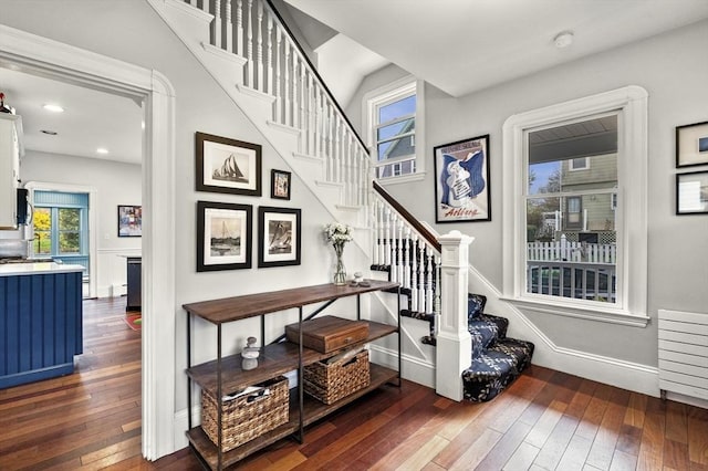 stairway with recessed lighting, baseboards, and hardwood / wood-style flooring