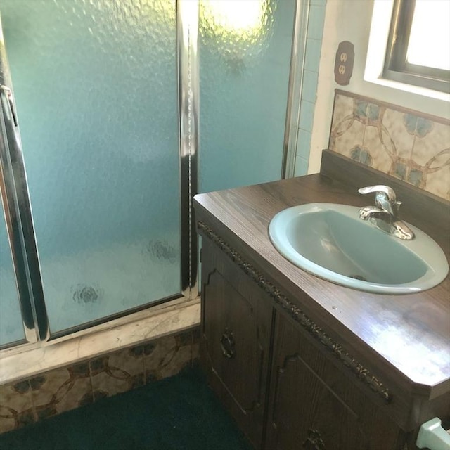 bathroom featuring a shower stall and vanity
