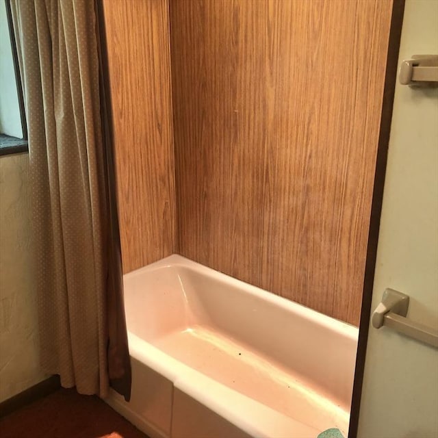 bathroom with shower / bath combination with curtain