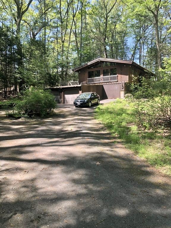 view of side of property with asphalt driveway