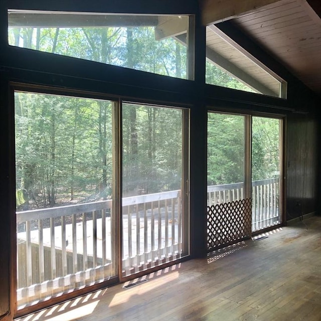 unfurnished sunroom with vaulted ceiling and healthy amount of natural light