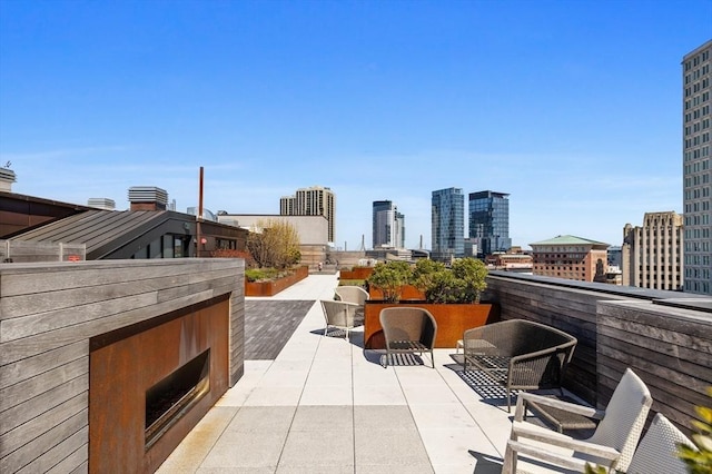 45 Temple St Unit 410, Boston, MA 02114 - view of patio / terrace featuring a city view and an outdoor brick fireplace