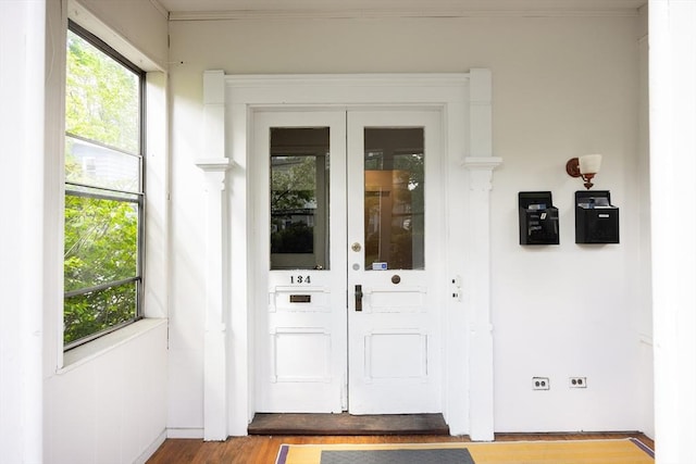 134 Brown St, Waltham, MA 02453 - doorway to outside featuring wood finished floors