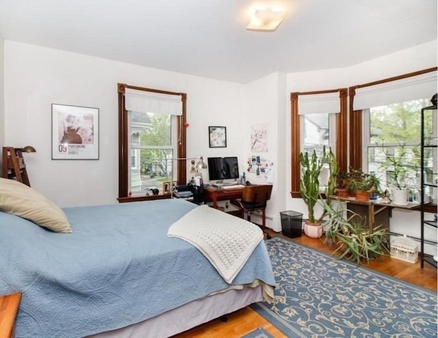 134 Brown St, Waltham, MA 02453 - bedroom featuring multiple windows and wood finished floors