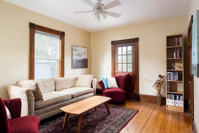 134 Brown St, Waltham, MA 02453 - living room with a ceiling fan, light wood-style floors, and baseboards