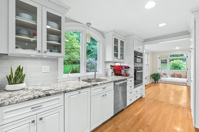 4 Worthen Rd, Winchester, MA 01890 - kitchen featuring appliances with stainless steel finishes, white cabinets, tasteful backsplash, light wood-style flooring, and recessed lighting