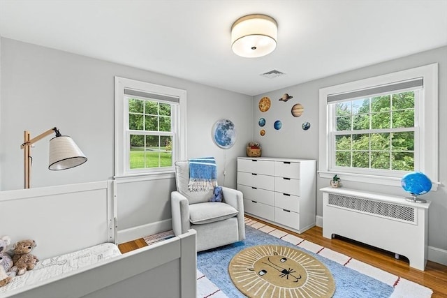 4 Worthen Rd, Winchester, MA 01890 - sitting room with radiator, plenty of natural light, and light wood-style floors