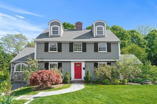 4 Worthen Rd, Winchester, MA 01890 - view of front of home featuring a chimney, a front lawn, and roof with shingles