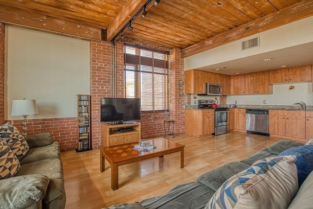 147 Centre St Unit 201, Brockton, MA 02302 - living room featuring brick wall, wood ceiling with exposed beams, light wood-style floors, and track lighting