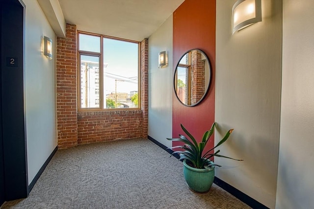 147 Centre St Unit 201, Brockton, MA 02302 - corridor with carpet, baseboards, and brick wall
