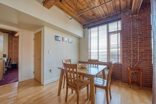 147 Centre St Unit 201, Brockton, MA 02302 - dining space with brick wall, light wood finished floors, wooden ceiling with exposed beams, and baseboards