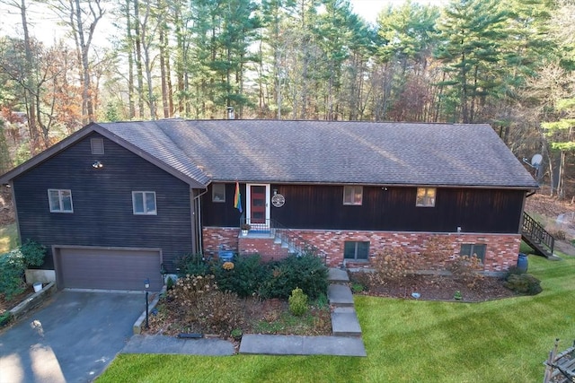 view of front of house with a garage and a front yard