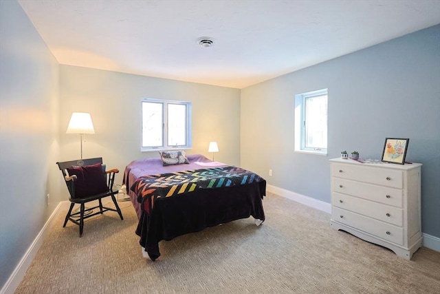 bedroom featuring multiple windows and light carpet