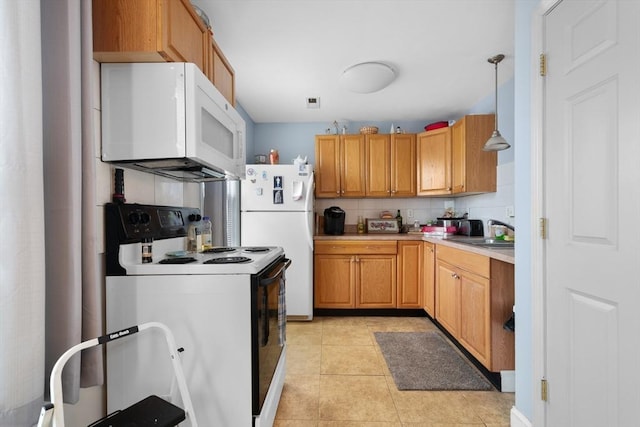 kitchen with backsplash, white appliances, light tile patterned flooring, hanging light fixtures, and sink