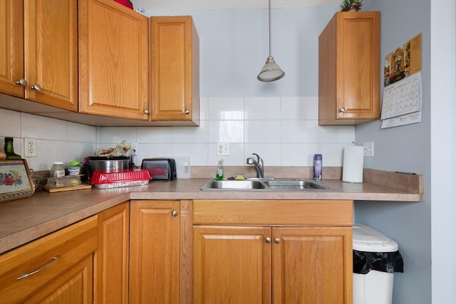 kitchen featuring sink, pendant lighting, and tasteful backsplash