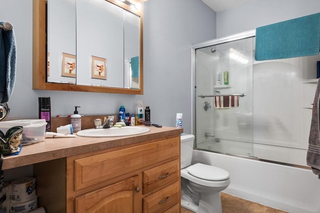 full bathroom featuring toilet, combined bath / shower with glass door, tile patterned flooring, and vanity