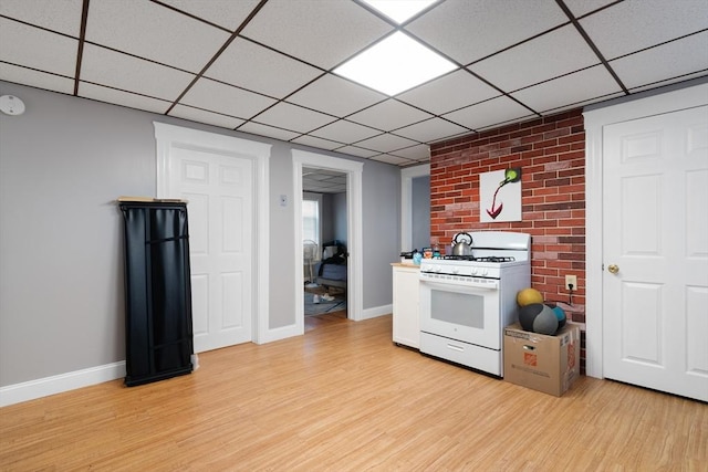 kitchen featuring white gas range and light hardwood / wood-style flooring