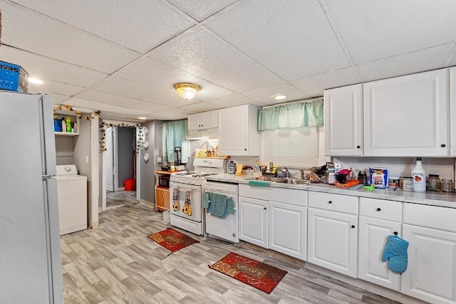205-207 High St, Fitchburg, MA 01420 - kitchen featuring white appliances, washer / clothes dryer, under cabinet range hood, a paneled ceiling, and white cabinets