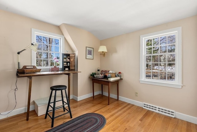 office space with wood finished floors, visible vents, and baseboards