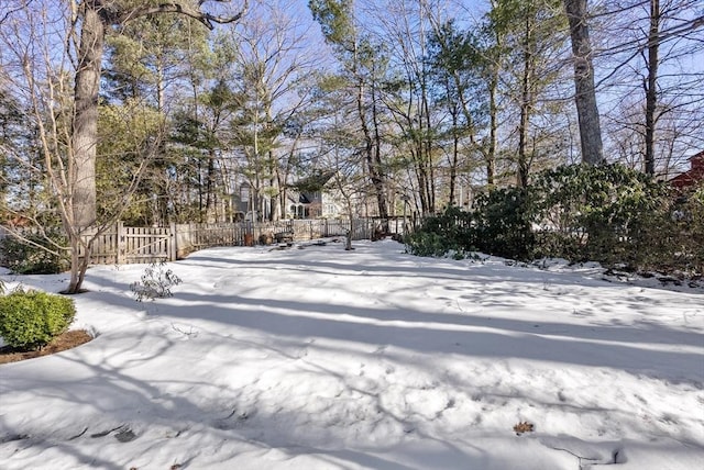 yard layered in snow with fence