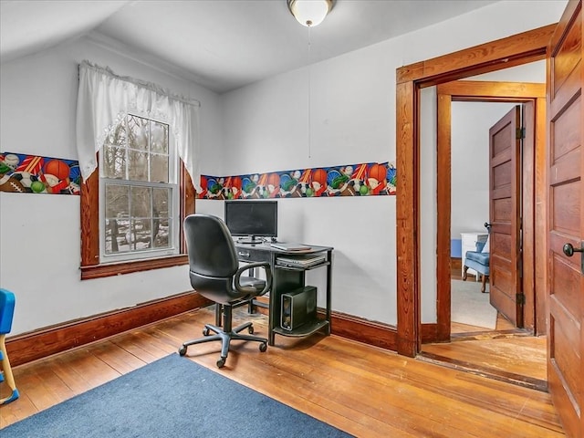 office space featuring vaulted ceiling, hardwood / wood-style flooring, and baseboards