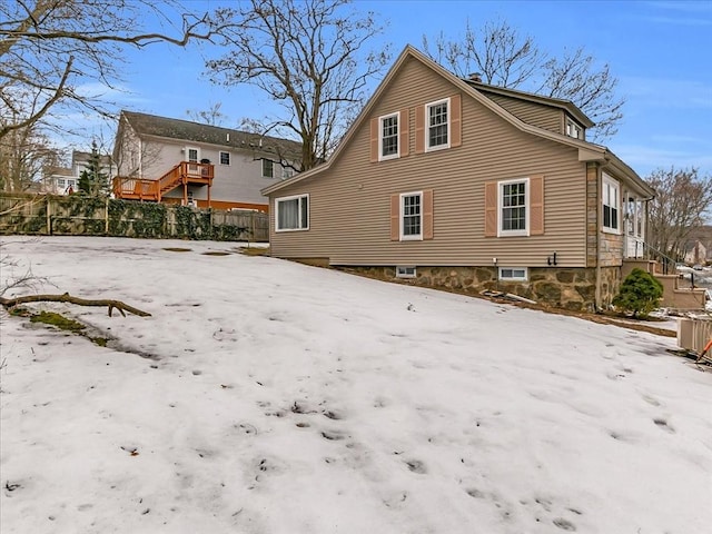 snow covered house with fence