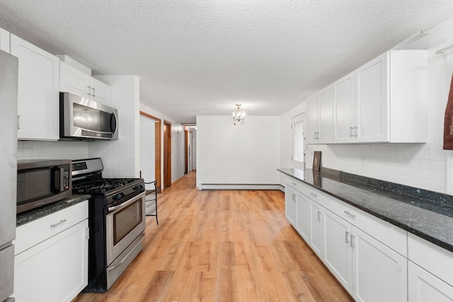 kitchen featuring stainless steel appliances, baseboard heating, light hardwood / wood-style flooring, a textured ceiling, and white cabinets