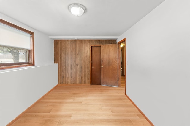 corridor with light hardwood / wood-style flooring