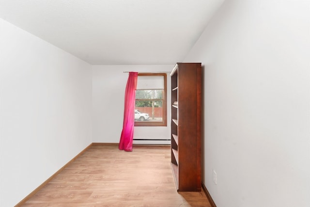 spare room with light hardwood / wood-style flooring and baseboard heating